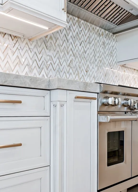 Mondern kitchen design with hand tiled backsplash and marble countertops